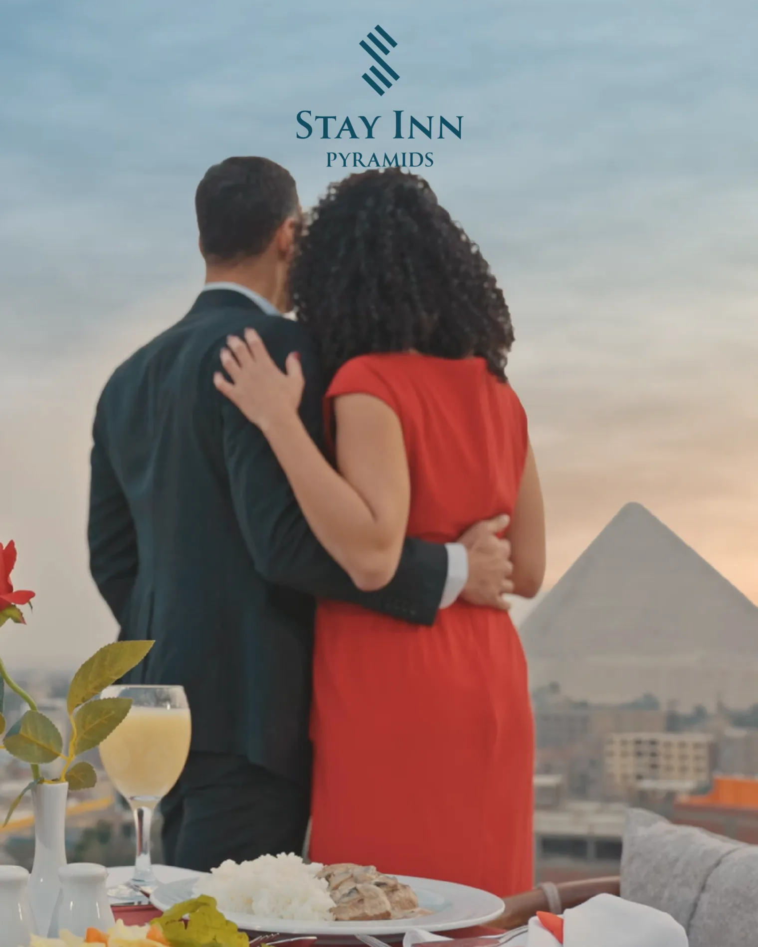 A couple celebrating with the Pyramids in view